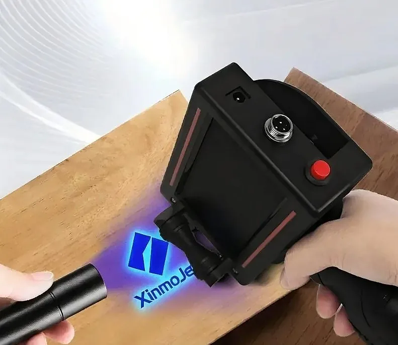 Illustration of a covert mark glowing blue/violet under a handheld 365 nm UV lamp, with a black TIJ handheld printer beside it